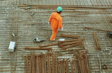 Construction working walking around among tools and materials