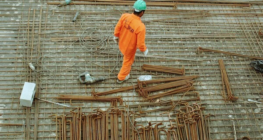 Construction working walking around among tools and materials
