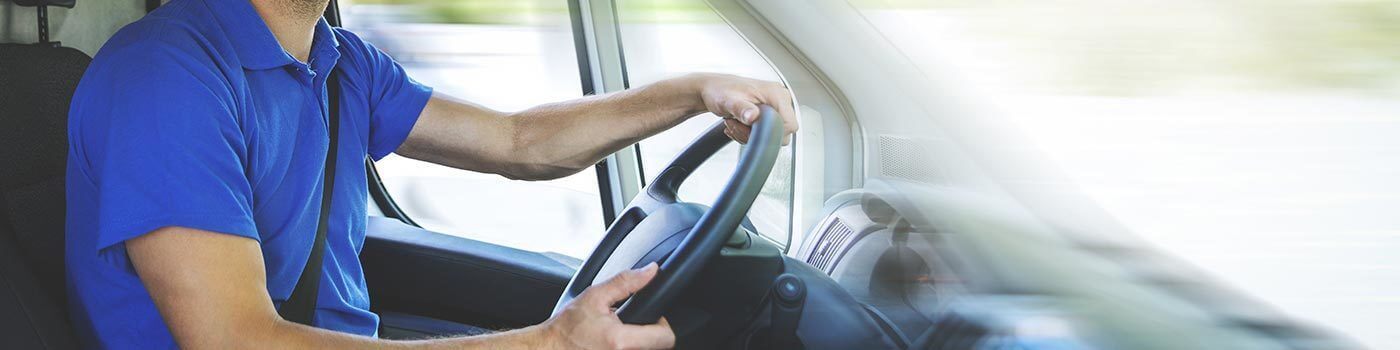 Transportation driver with hands on the wheel