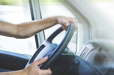 Transportation driver with hands on the wheel