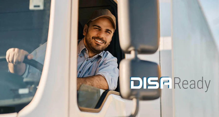 Truck driver leaning out the window smiling with DISAReady logo