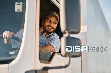Truck driver leaning out the window smiling with DISAReady logo