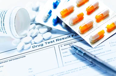 prescription drugs spilled onto a drug test result form