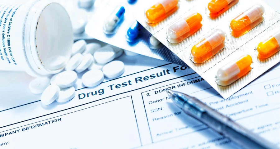 prescription drugs spilled onto a drug test result form