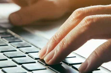 fingers on a laptop