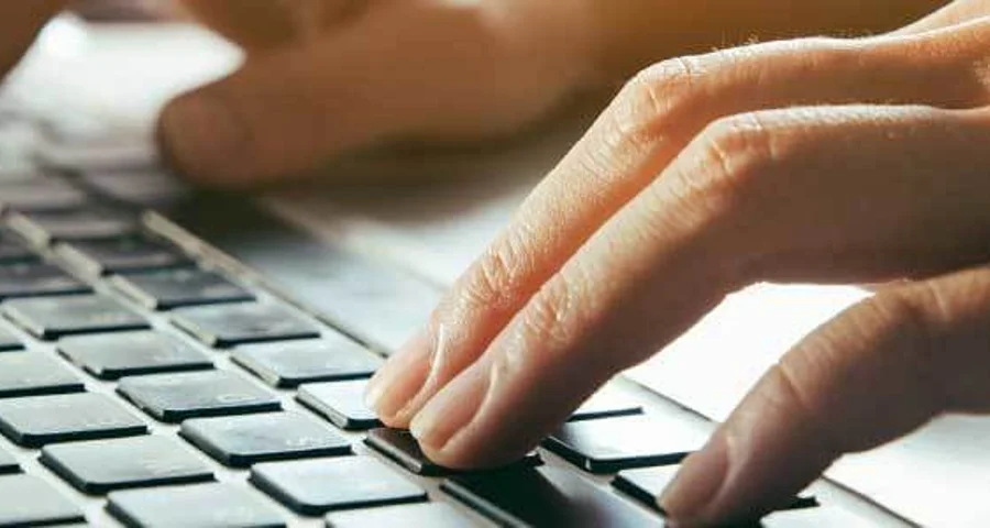 fingers on a laptop