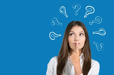 woman looking inquisitive with question marks around her head