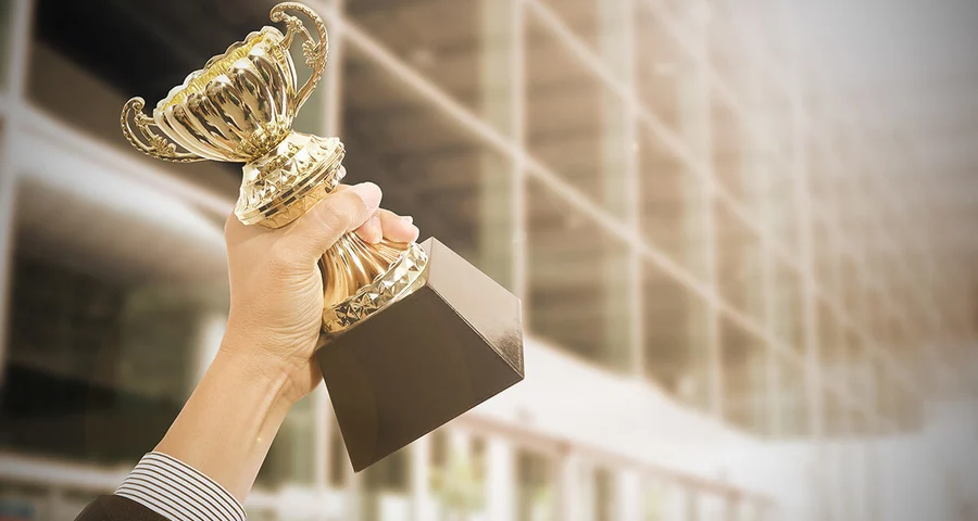 employee holding award celebration