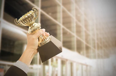 employee holding award celebration