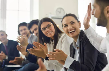 employees coworkers applauding a colleague