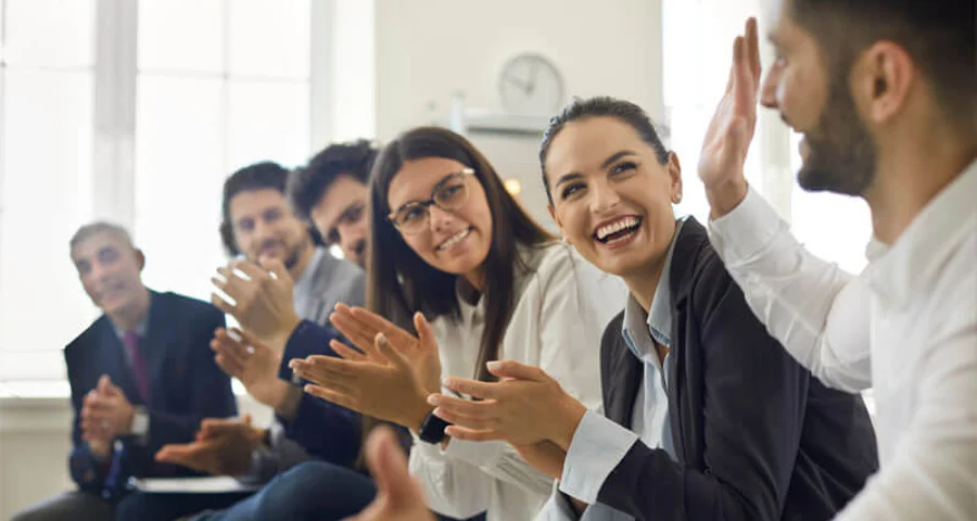 employees coworkers applauding a colleague