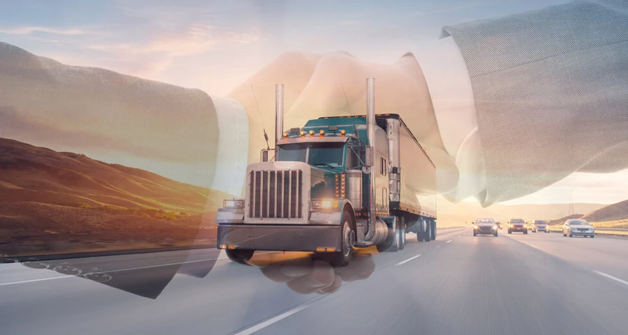 Handshake superimposed over an 18-wheel truck driving on the road