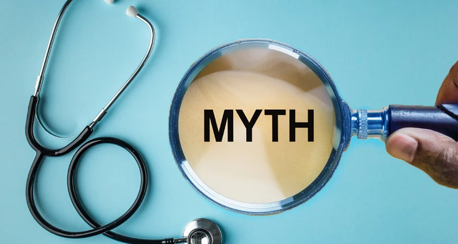 magnifying glass over the word myth and stethoscope