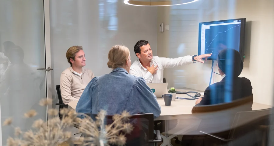 Team in a meeting discussing criminal record check