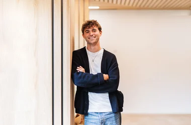 A male DISA colleague smiling in the office