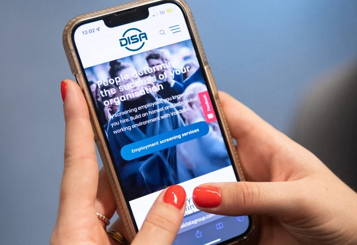 woman uses mobile phone to access DISA platform