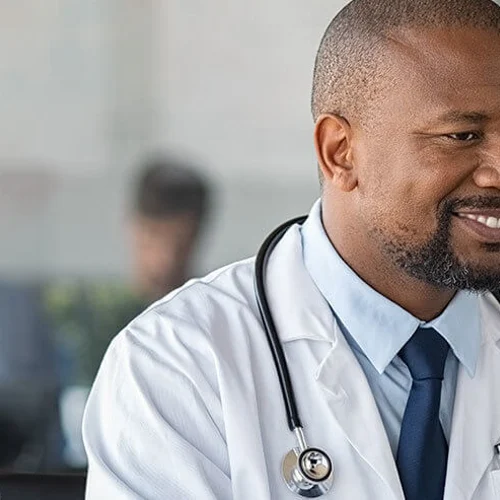 doctor working on a computer and smiling