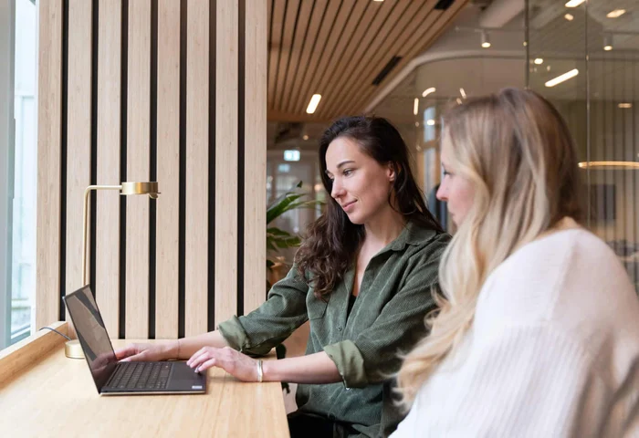 two female employees looking at laptop