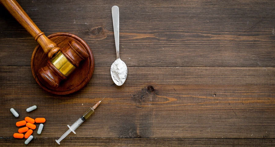 legal gavel and drugs pills needle injection