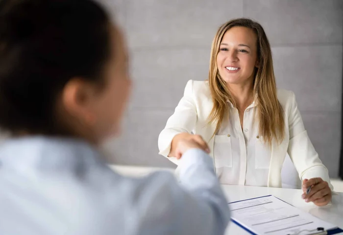 business professionals smiling and shaking hands