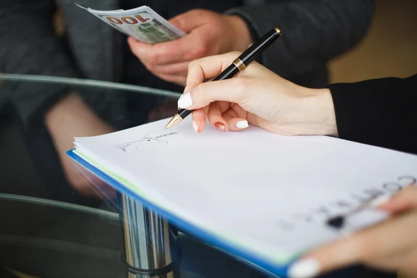 person paying for a signature - corrupt official
