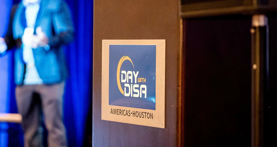 Day with DISA logo on a podium with speaker in the background