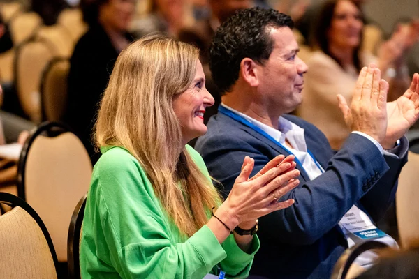 HR conference attendees clapping