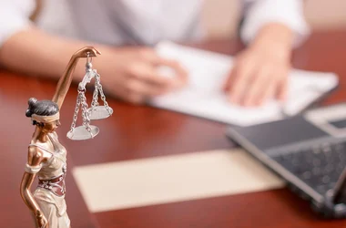 Scales of justice statue on a lawyer's desk