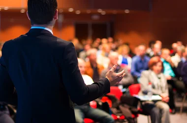 Speaker making a presentation at a Conference