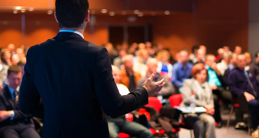 Speaker making a presentation at a Conference