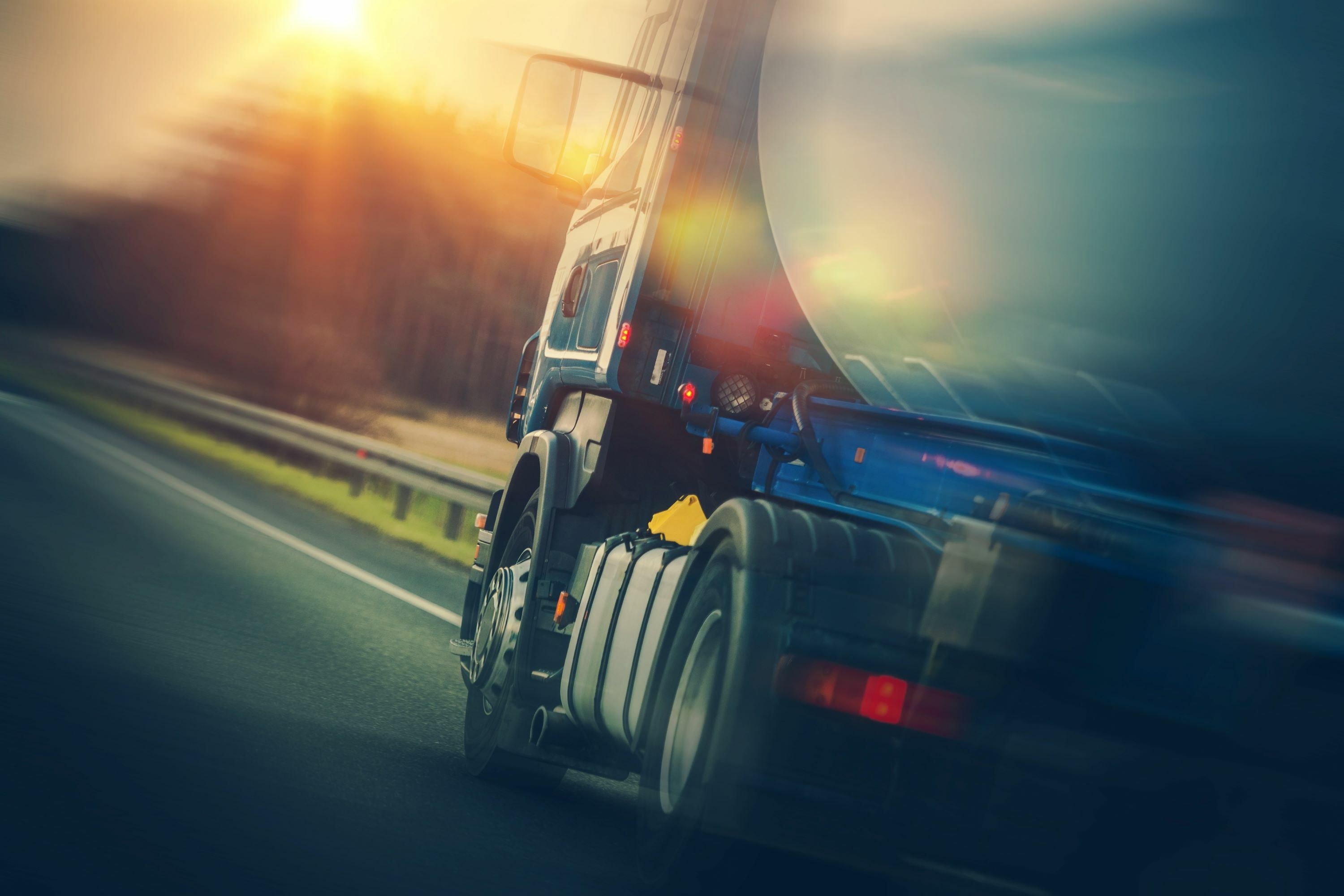 Close up of a truck transporting oil driving on the highway