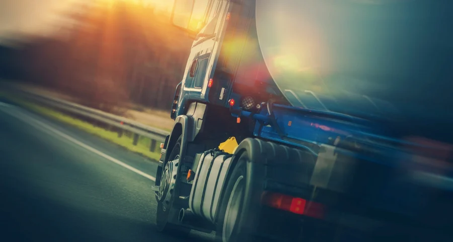 Close up of a truck transporting oil driving on the highway
