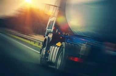 Close up of a truck transporting oil driving on the highway