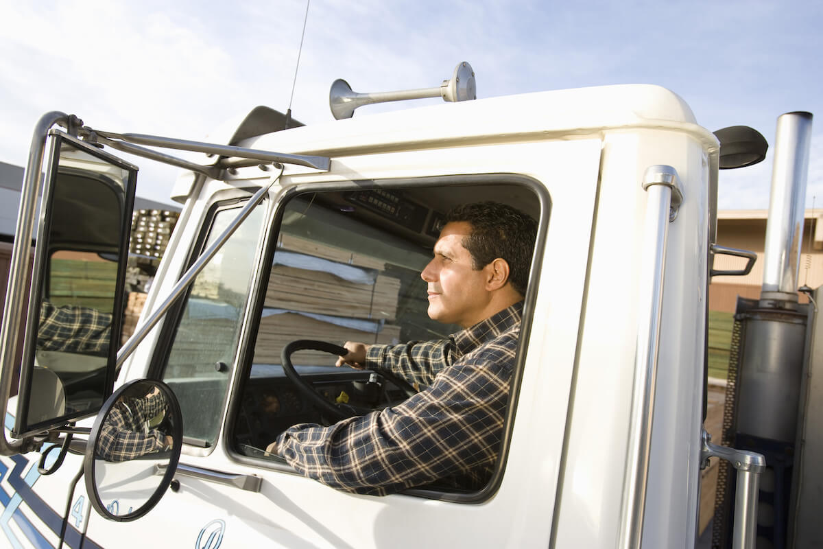 Truck driver driving with the window down