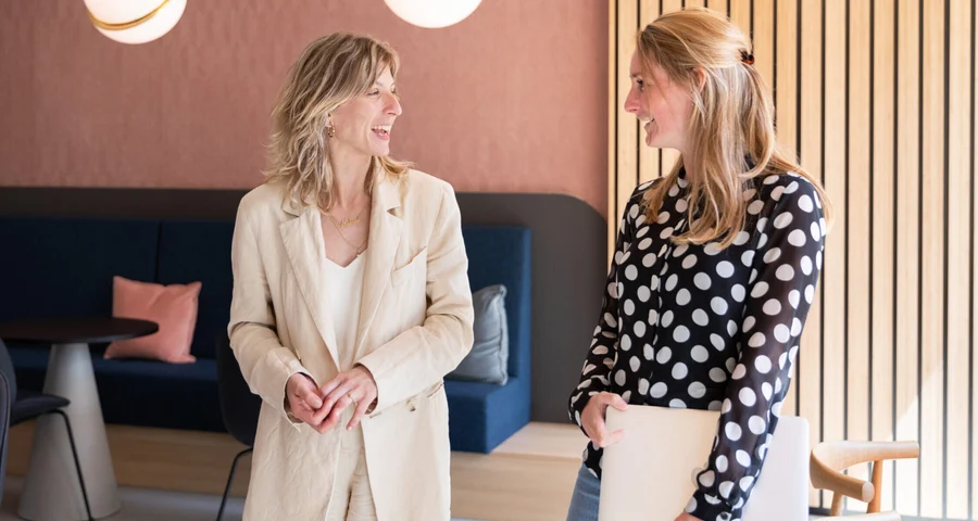 Two colleagues smiling and talking