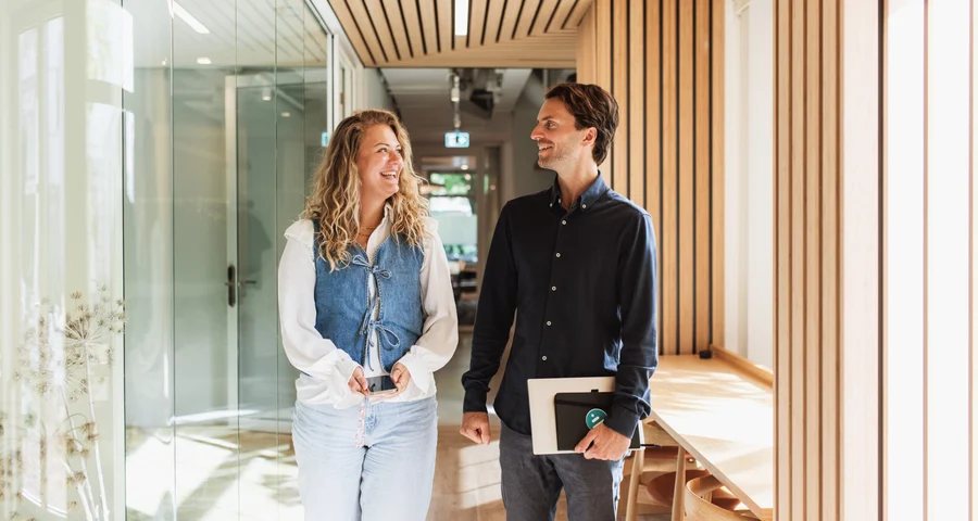 Twee collega's lopen in een gang
