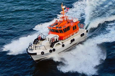 A Coast Guard boat racing through the waves