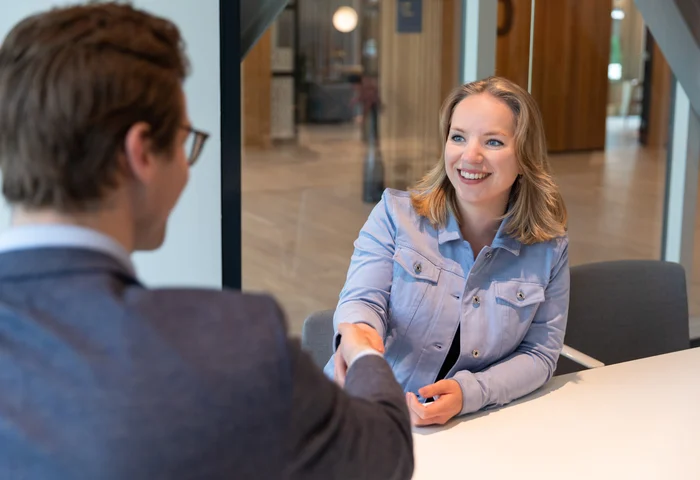 cheerful woman shaking hands with hiring manager