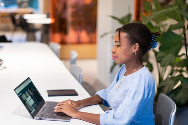 Woman sitting at a desk working on her laptop