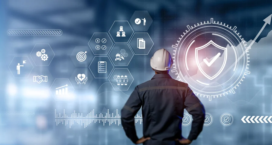man wearing a hard hat looking at icons regarding workplace safety