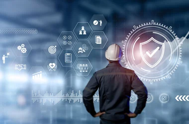 man wearing a hard hat looking at icons regarding workplace safety