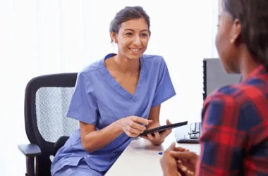 Healthcare worker collecting patient data on a tablet