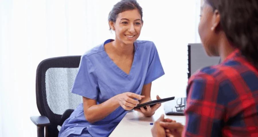 Healthcare worker collecting patient data on a tablet