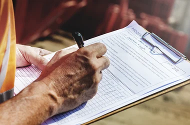 site safety inspector taking notes on a clipboard